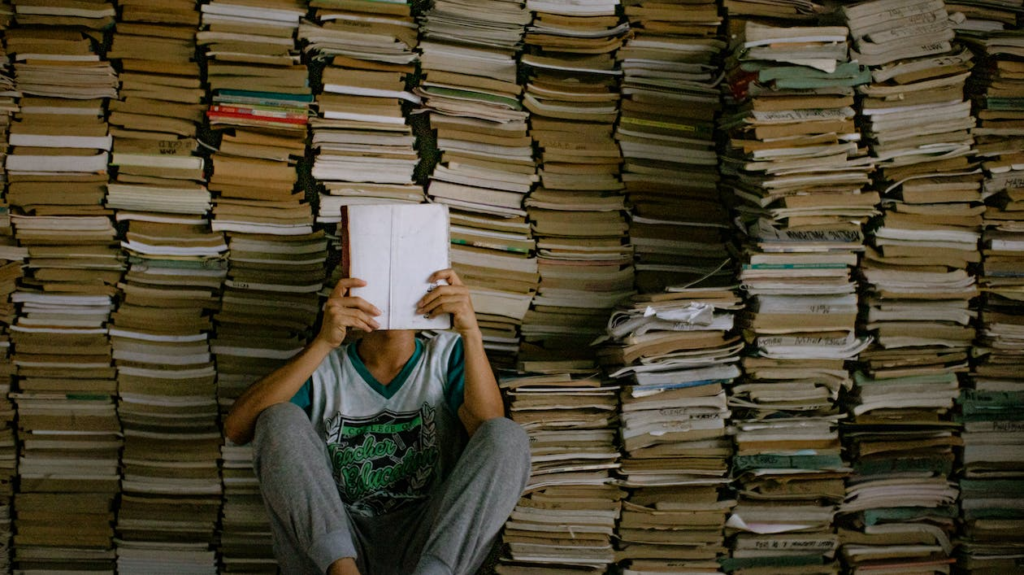 Photo by Nothing Ahead from Pexels: https://www.pexels.com/photo/person-reading-a-book-5009082/